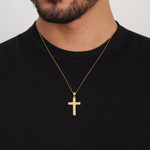 The 14K Solid Gold Nugget Texture Cross Necklace for Men showcases a textured design on a solid gold cross, exemplifying Christian jewelry elegance as it hangs from a delicate chain against a plain white background.