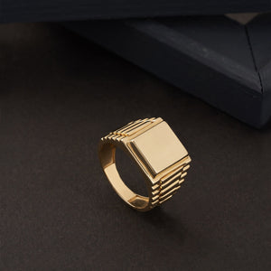 Discover the perfect men's jewelry statement piece: the 14K Solid Gold Watch Style Fancy Signet Ring for Men. This ring showcases a stunning engraved signet with a large rectangular top and ribbed band design, set against a white background.