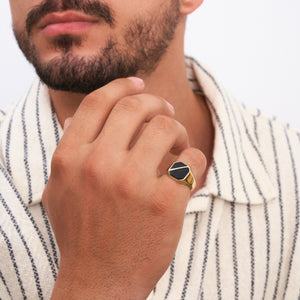 The 14K Solid Gold Black Enamel Signet Ring For Men features a sleek black octagonal face with a subtle angular design on top, presented against a plain white background.