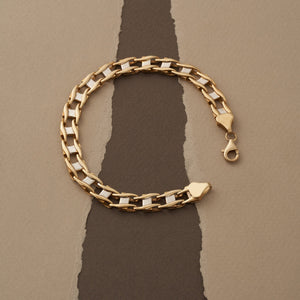 The 14K Solid Gold Classic Bracelet for Men showcases a lobster claw clasp and stackable interlocking links. Photographed against a plain white background, its polished and reflective surface is beautifully highlighted.