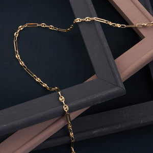 The 14K Solid Gold Paperclip & Puffed Mariner Anchor Link Chain Necklace showcases a striking combination of oval and elongated rectangular links, crafted in a distinctive paperclip and puffed mariner anchor link pattern. Its design is both simple and elegant, with a clean and polished finish.