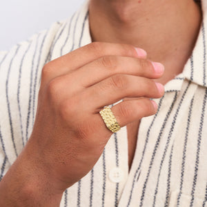 The 14K Solid Gold Nugget Texture Ring for Men showcases a distinct pattern of raised geometric shapes on its surface, evoking the appearance of a solid gold nugget. Set against a simple white background, this ring embodies the sophistication of handmade jewelry.