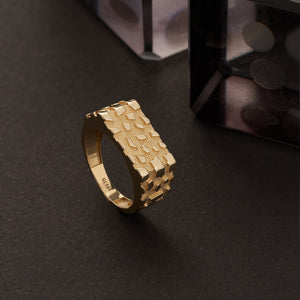 The 14K Solid Gold Nugget Texture Ring for Men showcases a distinct pattern of raised geometric shapes on its surface, evoking the appearance of a solid gold nugget. Set against a simple white background, this ring embodies the sophistication of handmade jewelry.