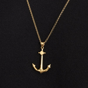 The 14K Gold Polished Minimal Anchor Pendant Necklace for Men, featuring a detailed pendant on a fine chain against a plain white background, makes an ideal sailor gift.