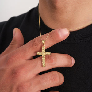 The 14K Solid Gold Nugget Texture Cross Necklace for Men showcases a textured design on a solid gold cross, exemplifying Christian jewelry elegance as it hangs from a delicate chain against a plain white background.