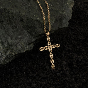 The 14K Solid Gold Puffed Anchor Mariner Cross Necklace for Men showcases a cross pendant adorned with delicate, oval-shaped patterns. This exquisite piece of Christian jewelry gracefully sits on a classic chain, highlighted against a white background.