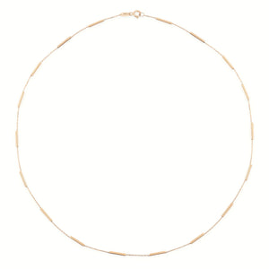 The 14K Solid Gold Bar Station Chain Necklace for Men features minimalist cylindrical bead accents evenly spaced along the fine chain, creating a simple and elegant circular design.