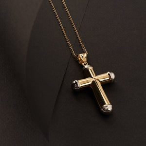 A 14K Solid Gold Cross Necklace for Men elegantly hangs on a gold chain against a white background. The cross, showcasing rounded silver tips at each end, exudes a sleek and polished appearance, ideal for those in search of Christian-Inspired Accessories.