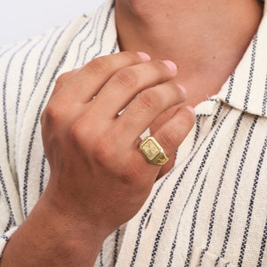 Introducing the 14K Solid Gold Watch Style Fancy Signet Ring for Men, showcasing a rectangular top finely engraved with an intricate sunburst pattern. This elegant piece of men's jewelry features a band adorned with geometric designs and a polished finish, adding a touch of sophistication and modernity to its appearance.