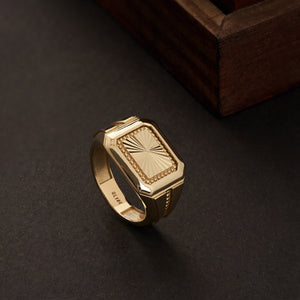 Introducing the 14K Solid Gold Watch Style Fancy Signet Ring for Men, showcasing a rectangular top finely engraved with an intricate sunburst pattern. This elegant piece of men's jewelry features a band adorned with geometric designs and a polished finish, adding a touch of sophistication and modernity to its appearance.