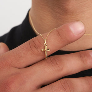 The 14K Gold Tiny Cross Necklace for Men showcases a small, polished cross pendant gracefully centered on a chain of fine, uniform links. This piece of religious jewelry offers a simple and elegant look, ideal for those seeking understated men's gold cross necklaces.