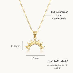 The 14K Gold Rising Sun Necklace showcases a delicate chain adorned with a sunburst pendant. This semi-circular pendant, featuring pointed rays, radiates celestial charm. Elegantly handcrafted from fine gold, the piece is beautifully presented on a plain white background.