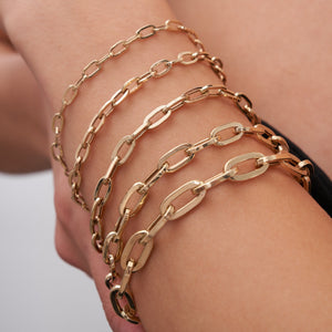 Displayed against a plain white background are five horizontal rows of gold chains, each embodying the elegance of fancy Italian design. Crafted using sustainable methods by RundaJewelryUs, these chains feature oval-shaped links in varying sizes and styles, including the refined 14K Real Solid Gold Paperclip Chain Bracelet.