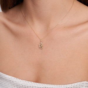 The 14K Solid Gold Trio Heart Pendant Necklace by RundaJewelryUs is crafted in 14K yellow gold and features a pendant with three interlocking heart shapes. The elegant design is suspended from a delicate chain, highlighting the shiny gold finish with a commitment to sustainable methods.