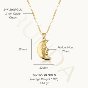 The 14K Real Gold 3D Puffed Moon Necklace is skillfully crafted from exquisite real gold and showcases a crescent moon pendant with an artful face profile. This celestial jewelry piece elegantly hangs from a delicate gold chain against a white background.